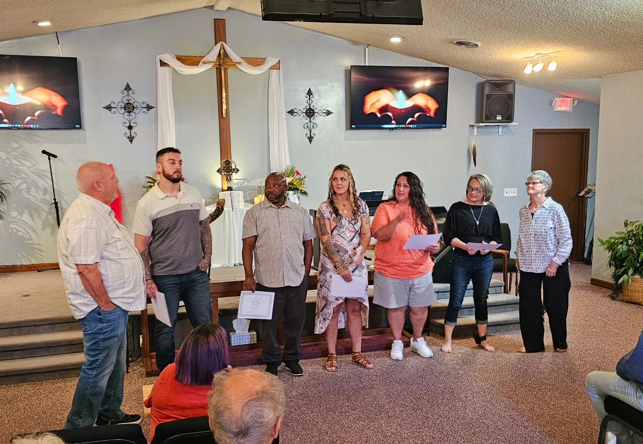 GAP graduates and staff standing together during a graduation ceremony at Stars of Light Chapel